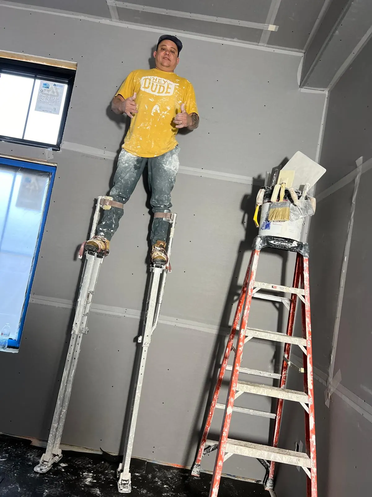 L&A plasterer finishing a ceiling on stilts